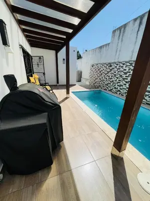 a patio with a pool and a table and chairs at Modern 3BR with private pool near the beach in Puerto Plata