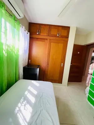 a bedroom with a bed and wooden cabinets at Modern 3BR with private pool near the beach in Puerto Plata