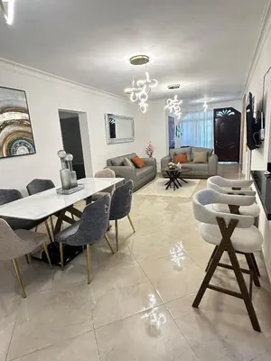 a living room with a white table and chairs at Modern and fully equipped house in Samaná in Santa Bárbara de Samaná