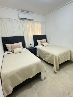 two beds sitting in a room withermottermott at Modern and fully equipped house in Samaná in Santa Bárbara de Samaná