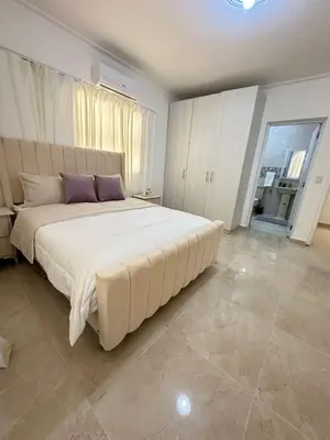 a large bedroom with a large white bed with purple pillows at Modern and fully equipped house in Samaná in Santa Bárbara de Samaná