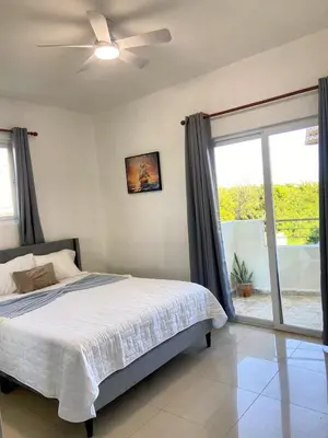 a bedroom with a bed and a ceiling fan at Modern 2BR Condo Near the Beach Juan Dolio in Villas del Mar