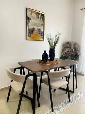 a dining room table with two chairs and a table at Modern 2BR Condo Near the Beach Juan Dolio in Villas del Mar