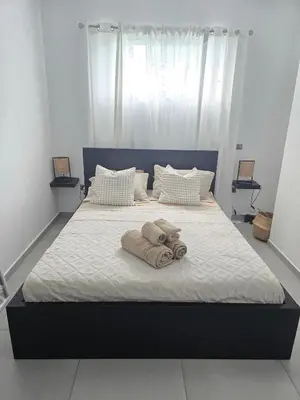 a bed with towels on top of it at Estrella Condos 8min walk to the beach Studio 201A in La Laguna