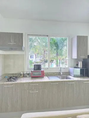 a kitchen with a sink and a window in it at Estrella Condos 8min walk to the beach Studio 201A in La Laguna