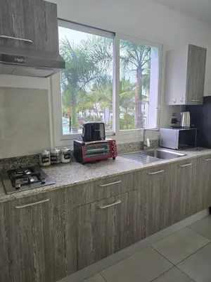 a kitchen with a sink and a microwave and a window at Estrella Condos 8min walk to the beach Studio 201A in La Laguna
