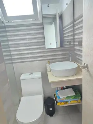 a bathroom with a white toilet and a sink at Estrella Condos 8min walk to the beach Studio 201A in La Laguna