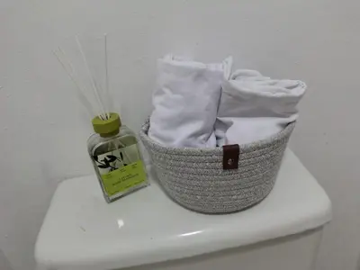 a basket on top of a toilet with a bottle of soap at La Guarida de Mela in Santo Domingo