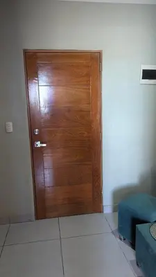 a wooden door in the corner of a room at Mitaly Apartamentos 111 in Santo Domingo
