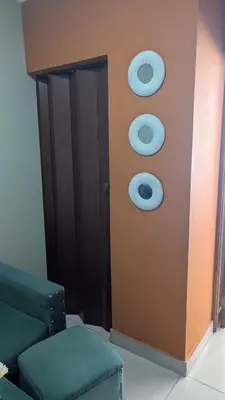 a room with a door with two mirrors on the wall at Mitaly Apartamentos 111 in Santo Domingo