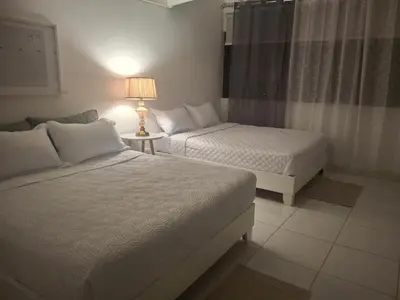 a bedroom with two beds and a lamp on a table at beautiful Penthouse in the middle of Sosua walking distance to everything in Sosúa