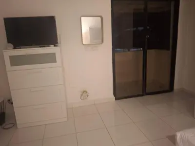 a room with a tv and a dresser with a tvictericter at beautiful Penthouse in the middle of Sosua walking distance to everything in Sosúa