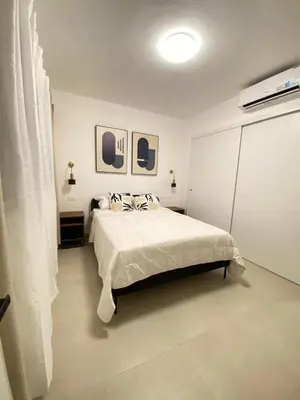 a bedroom with a bed and two pictures on the wall at Apartment in Punta Cana