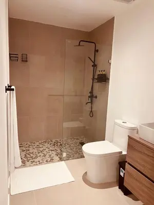 a bathroom with a shower and a toilet and a sink at Apartment in Punta Cana