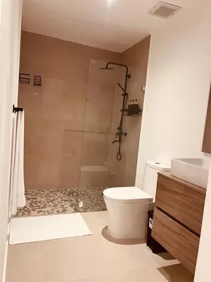 a bathroom with a shower and a toilet and a sink at Apartment in Punta Cana