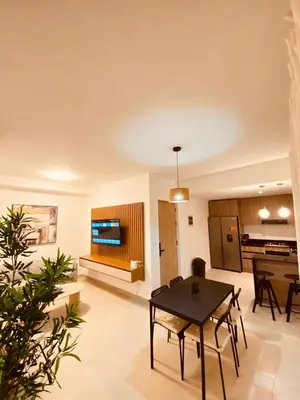 a living room with a table and a kitchen at Apartment in Punta Cana