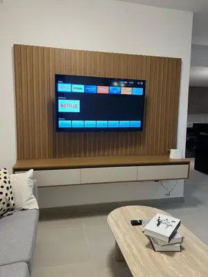 a living room with a tv on a wooden wall at Apartment in Punta Cana