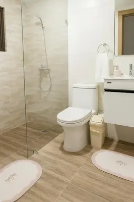 a bathroom with a toilet and a glass shower at Elegant Downtown Stay Santo Domingo in Santo Domingo