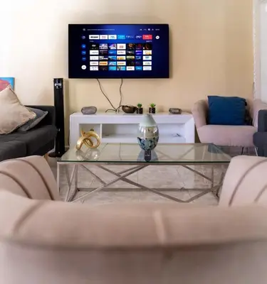 a living room with a glass coffee table and a tv at 4BR Villa Newly Renovated-5 min to Playa Dorada H1 in San Felipe de Puerto Plata