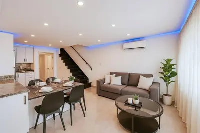 a living room with a couch and a table at Stylish Sosua 2 BR apartment near everything in Sosúa