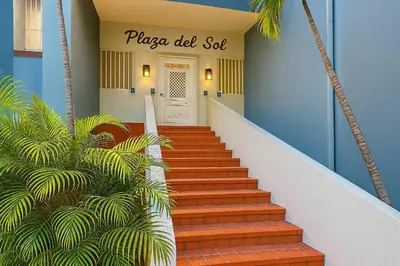 a staircase leading to a white door with a sign that reads pizza did set at Stylish Sosua 2 BR apartment near everything in Sosúa