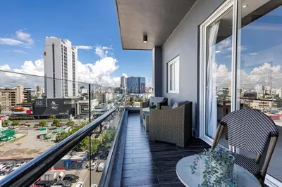 a balcony with a view of a city at Upscale City Center Condo, Pool, Gym in Santo Domingo