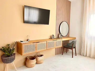 a living room with a television on a wall at Villa Palmera in Las Terrenas
