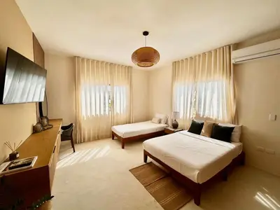 a hotel room with a bed and a couch at Villa Palmera in Las Terrenas