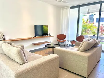 a living room with two couches and a flat screen tv at Villa Hazel in Las Terrenas