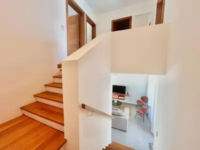 a staircase in a house with white walls and wooden floors at Villa Hazel in Las Terrenas