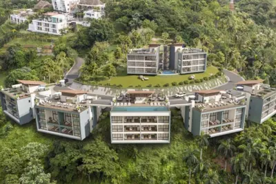 an aerial view of three buildings on a hill at Chic 2BR Apt 1km from Playa Bonita in Las Terrenas