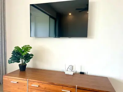 a potted plant sitting on top of a wooden dresser at Chic 2BR Apt 1km from Playa Bonita in Las Terrenas