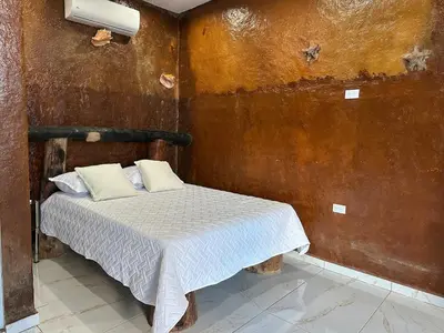 a small bedroom with a bed in a room at Guest-House Caracol 2- 4 Pax, vista al mar in Las Galeras