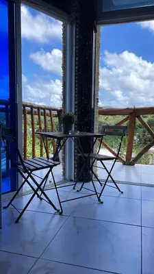 a table and two chairs on a balcony with a view at Guest-House Caracol 2- 4 Pax, vista al mar in Las Galeras