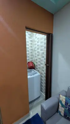 a living room with a couch and a refrigerator at Mitaly apartamentos Santo Domingo G in Santo Domingo