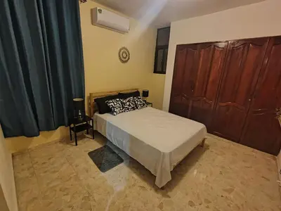 a bedroom with a bed and a large closet at Double room with private bathroom in Santo Domingo
