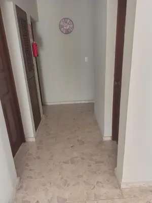 an empty hallway with a clock on the wall at Double room with private bathroom in Santo Domingo