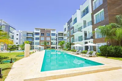 an image of a swimming pool at a apartment complex at Elegant 2BR Apt, Steps to Hard Rock in Punta Cana