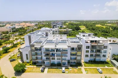 an aerial view of a large white building at Elegant 2BR Apt, Steps to Hard Rock in Punta Cana