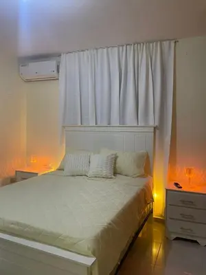 a bedroom with a bed with a window and two lights at Modern 3-bedroom apartment in a gated residential community in Concepción de La Vega