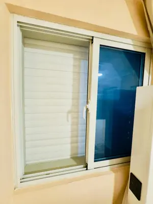 a window with a white roller blind on it at Luxurious 4 bedroom apartment near the beach in Ensanche Savica de Mendoza