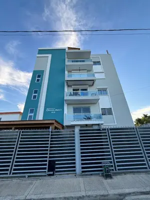 a tall building with a fence in front of it at Luxurious 4 bedroom apartment near the beach in Ensanche Savica de Mendoza