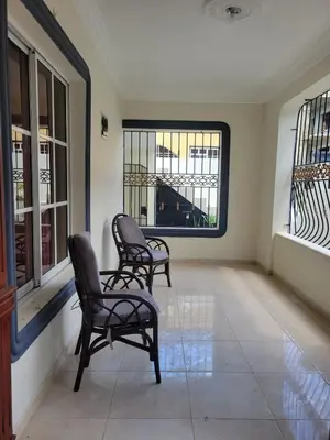 two chairs in a room with two windows at Spacious house with private parking in San Felipe de Puerto Plata