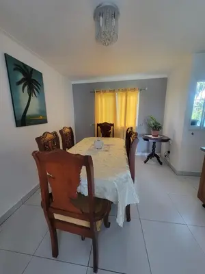 a dining room with a table and chairs at Palma Real Near Cibao Airport in Santiago de los Caballeros