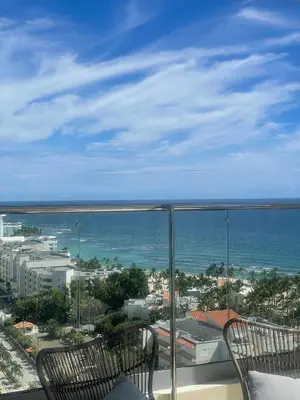 a balcony with two chairs and a view of the ocean at JuanDolio Penthouse 3 bedrooms Beachfront frente a hemingway in Los Corrales