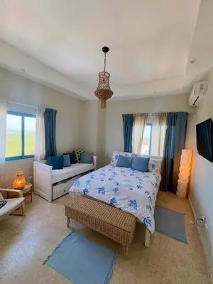 a bedroom with a bed and a couch at JuanDolio Penthouse 3 bedrooms Beachfront frente a hemingway in Los Corrales