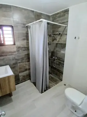 a bathroom with a shower curtain and a toilet at APARTAMENTO EXCLUSIVO Villa Privada Flamboyan in Bayahibe