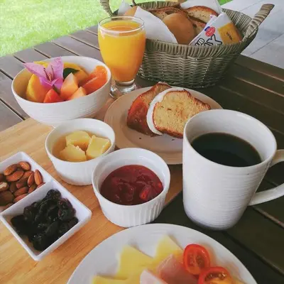 a table topped with plates of food and a cup of coffee at APARTAMENTO EXCLUSIVO Villa Privada Flamboyan in Bayahibe
