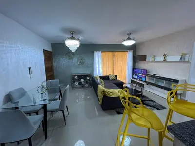 a living room with a couch and a dining room at Beautiful residential area near Avenida España in Los Mameyes