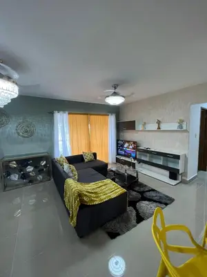 a living room with a couch and a television at Beautiful residential area near Avenida España in Los Mameyes